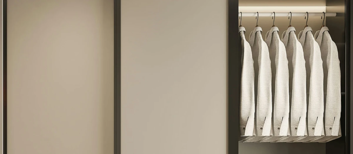 A beige wardrobe, opened by a third, showing seven identical white shirts, accurately hanged.